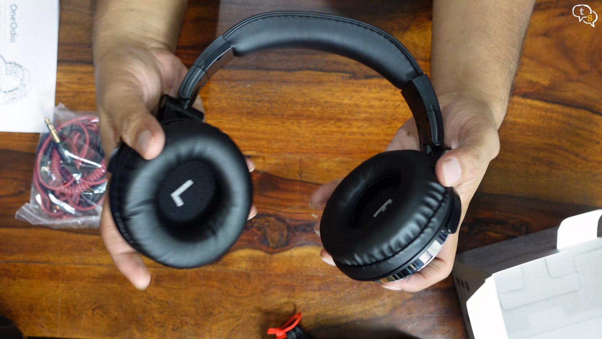 A person holding a pair of headphones Description automatically generated with low confidence