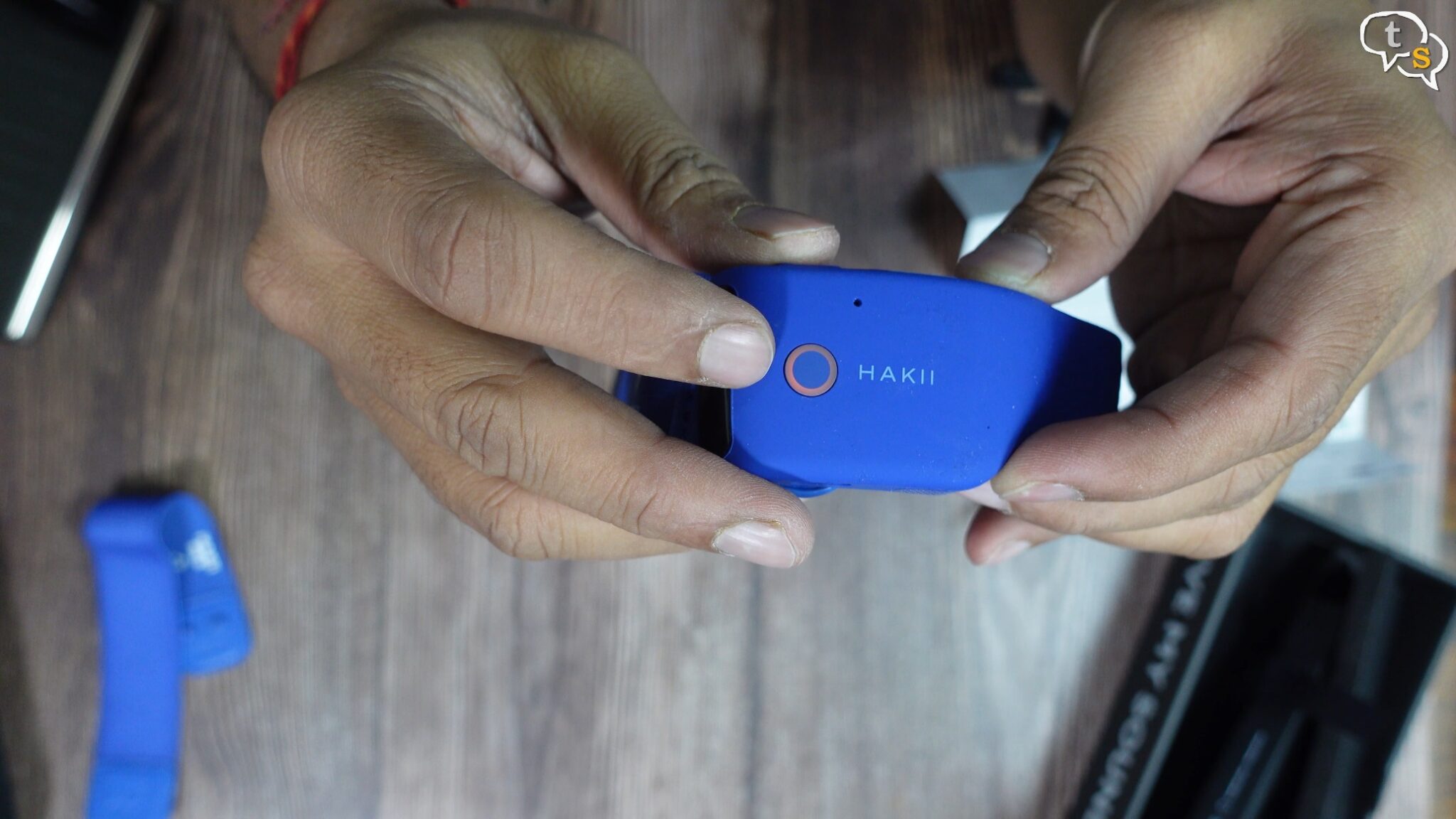 A person holding a blue device Description automatically generated with low confidence