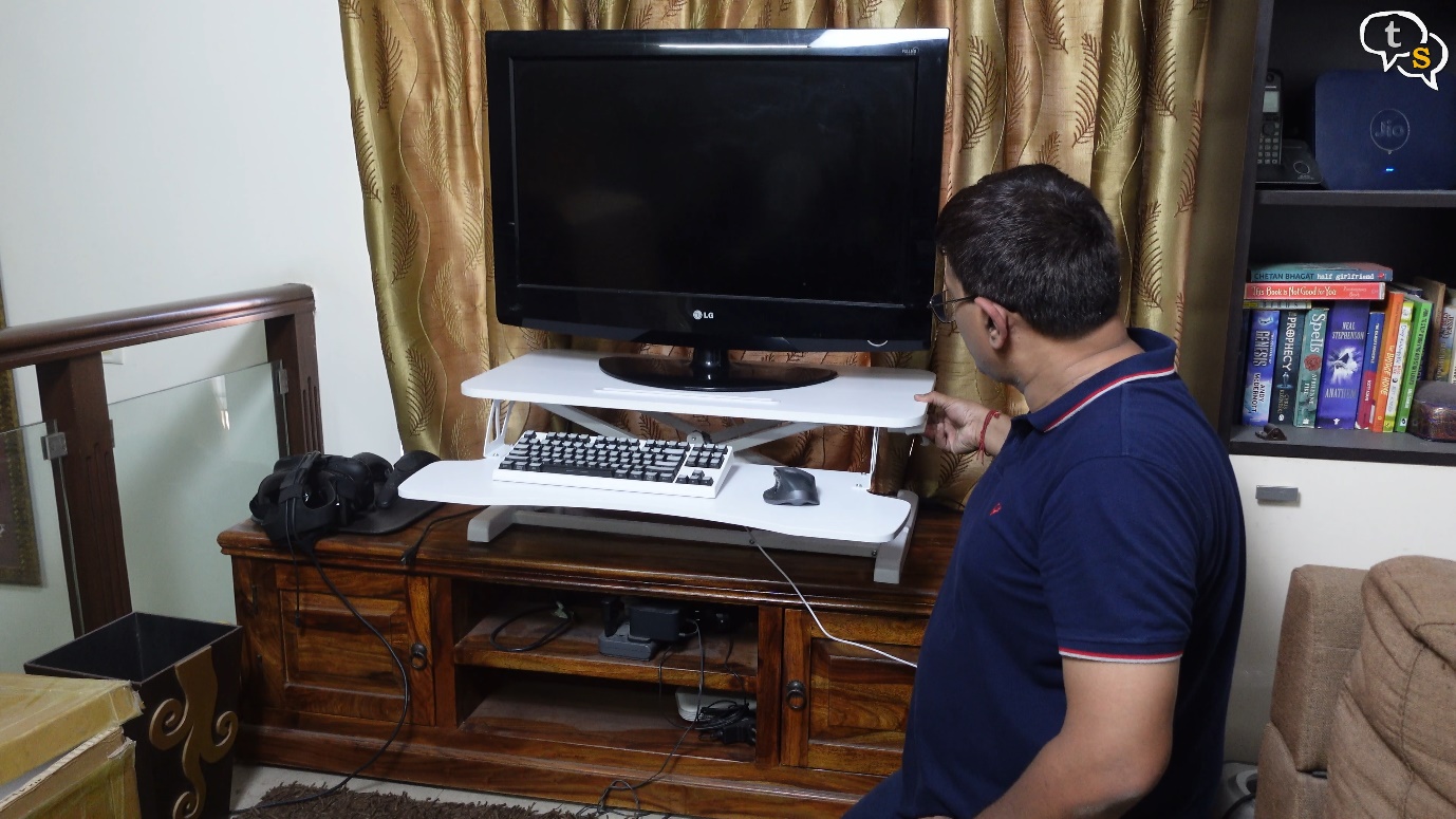 A person sitting in front of a tv Description automatically generated with medium confidence