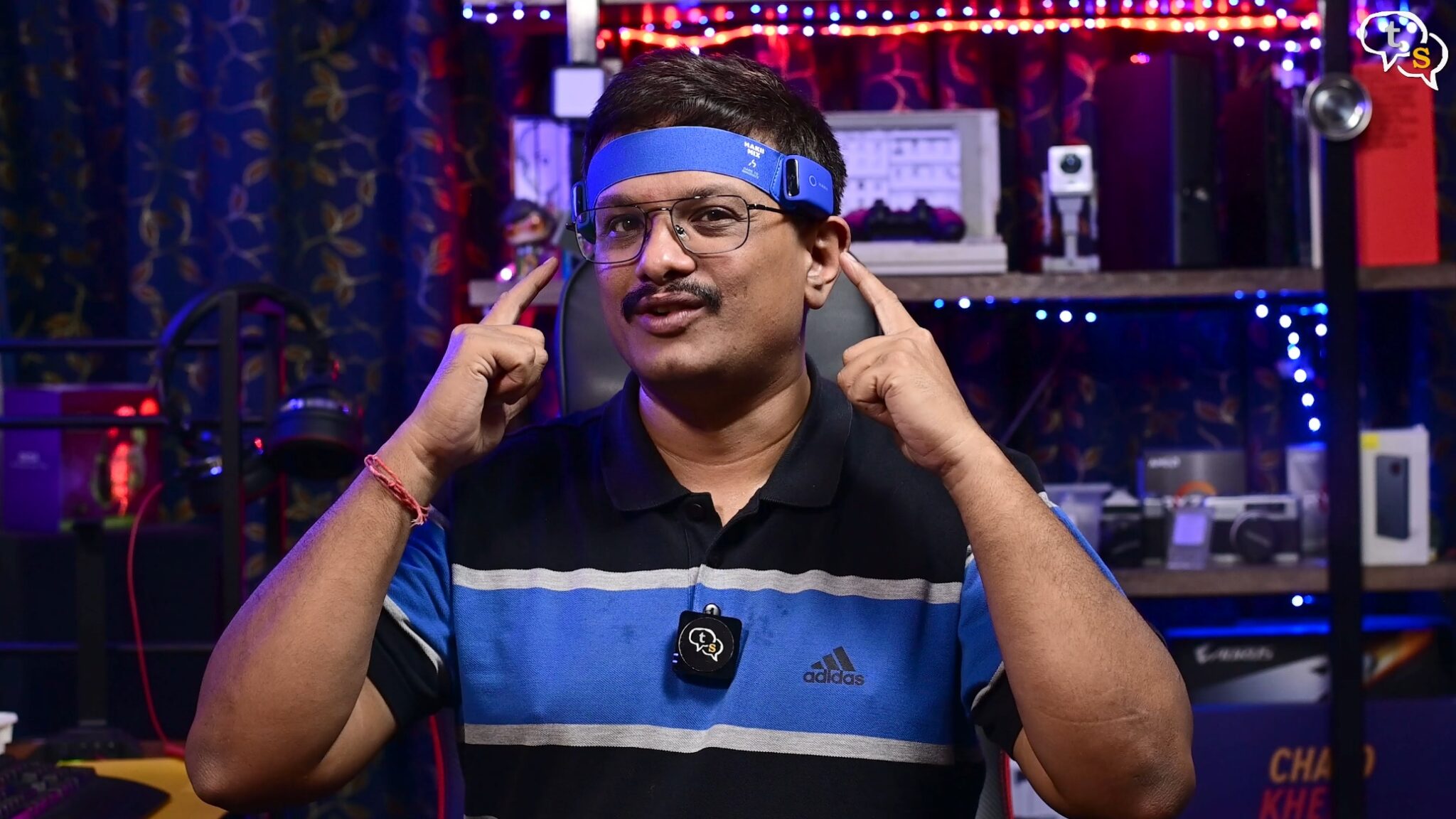 A person wearing a blue headband and glasses Description automatically generated with medium confidence