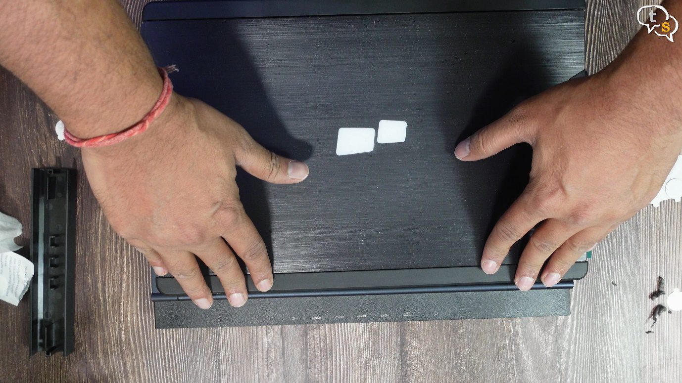 A person's hands on a black surface Description automatically generated with low confidence